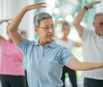 older woman working out in a group fitness class