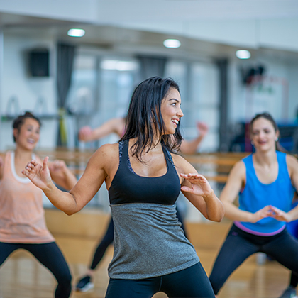 group of people dancing in a group exercise class